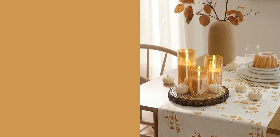 Candele dorate su una tovaglia festiva aggiungono un'atmosfera calda e invitante al tavolo da pranzo. 