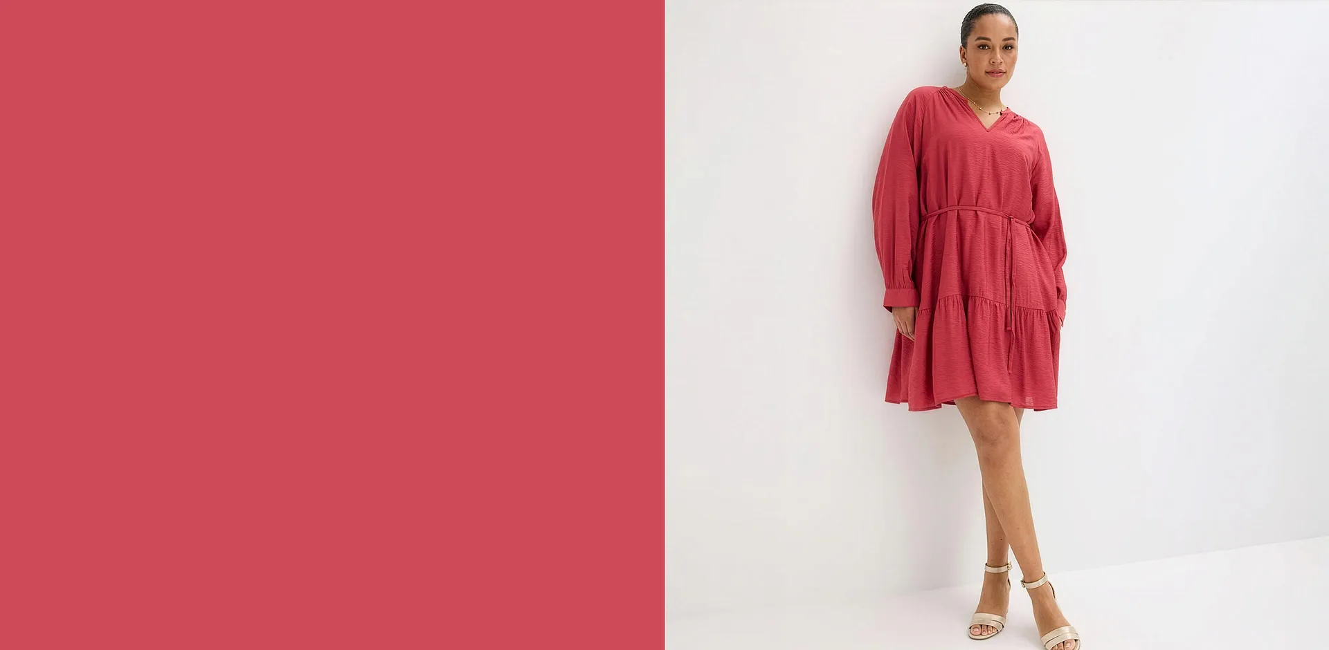 Un elegante abito rosso a maniche lunghe abbinato a sandali bianchi con tacco alto per un look raffinato.