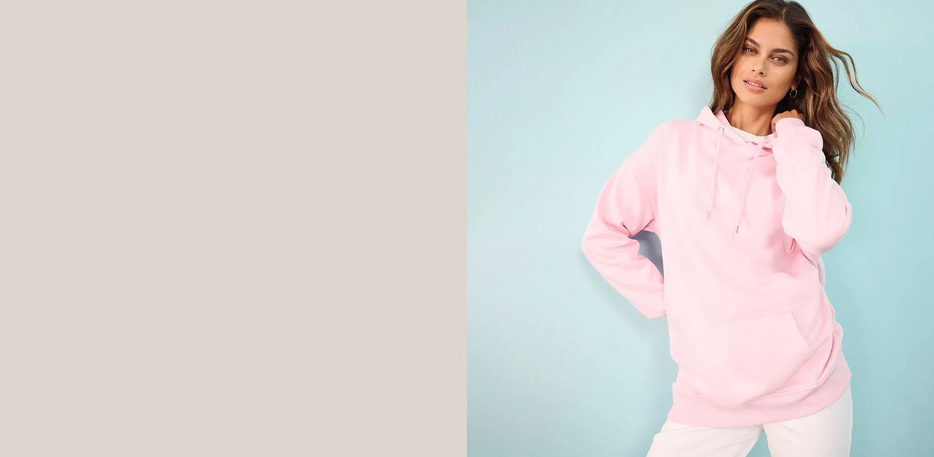 Felpa rosa con cappuccio abbinata a pantaloni bianchi.