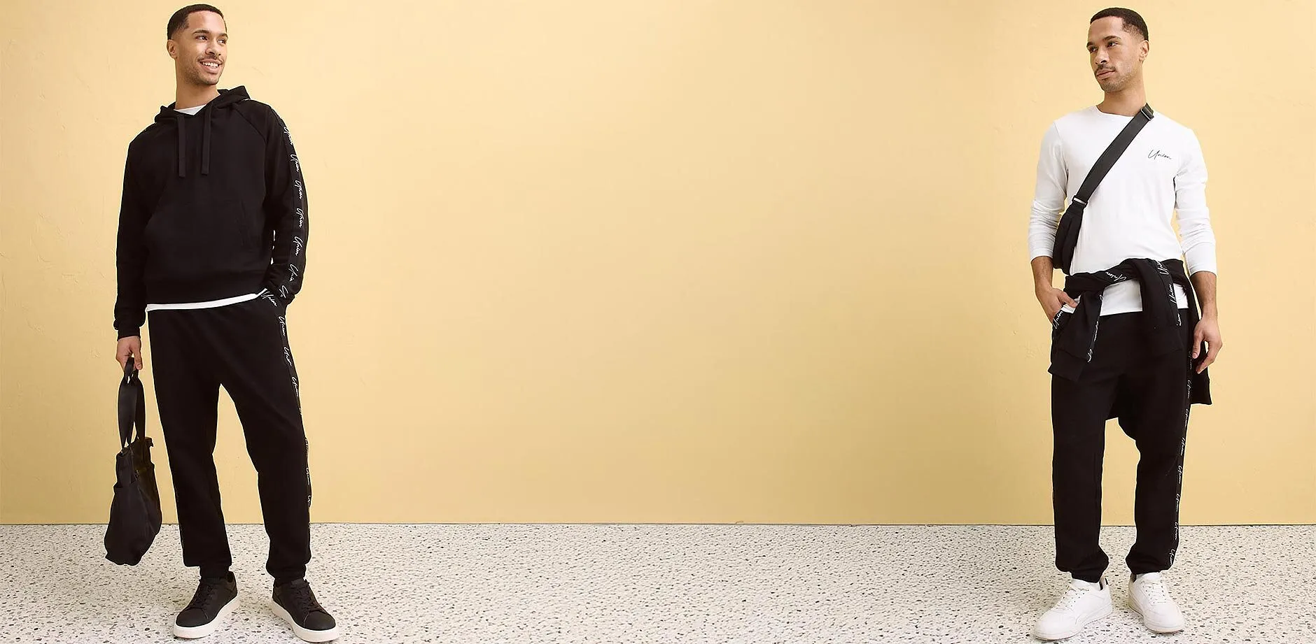 Maglietta bianca a maniche lunghe, pantaloni della tuta neri e borsa a tracolla nera.