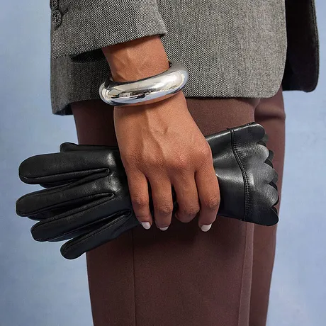 Bracciale d'argento e guanti di pelle neri.