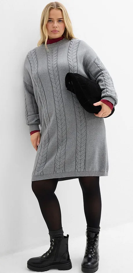 Abito grigio lavorato a maglia, collant neri e stivali stringati.