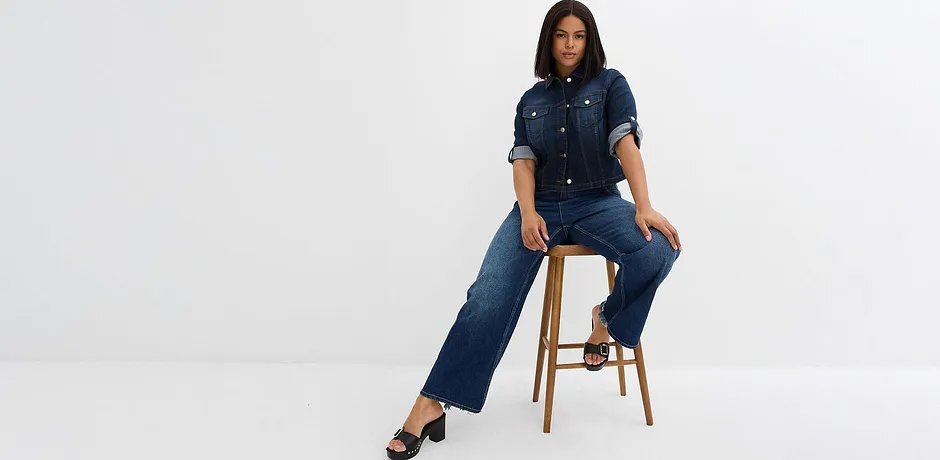 Jeans blu scuro abbinati a camicia di jeans.