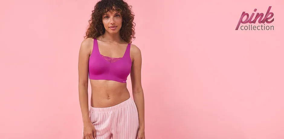 Outfit sportivo: crop-top lilla e pantaloni rosa a righe. Perfetto per il fitness e il tempo libero.