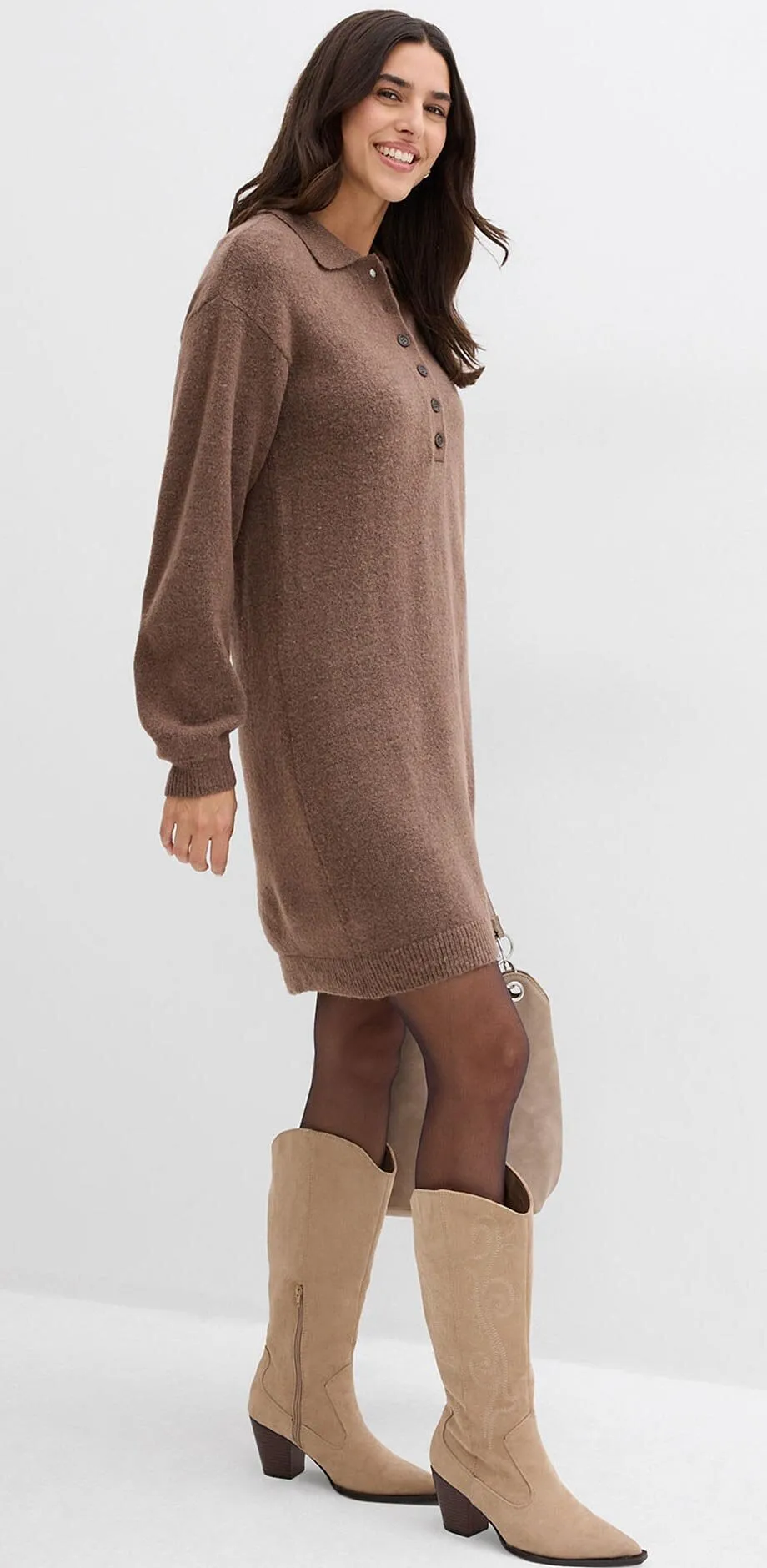Abito marrone lavorato a maglia con collo alto, abbinato a stivali chiari.