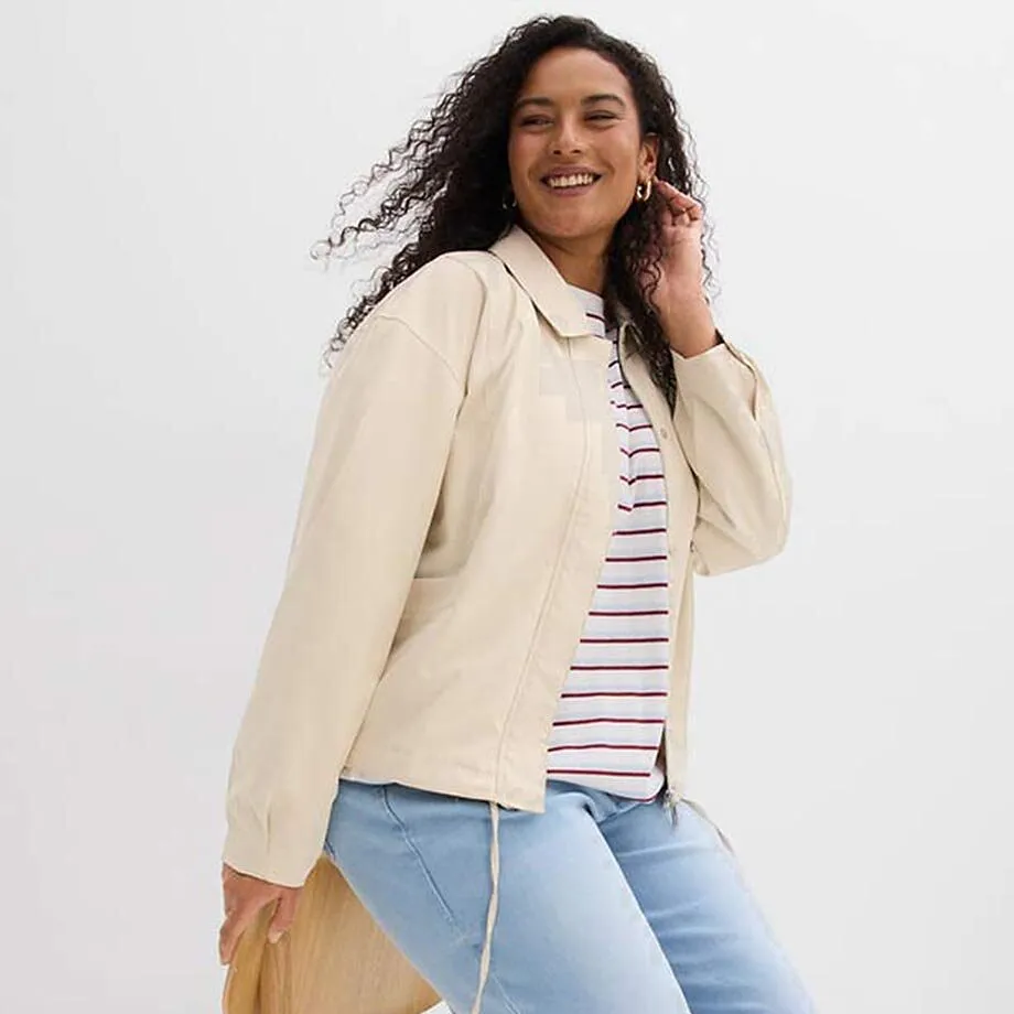 Giacca color crema sopra una maglietta a righe