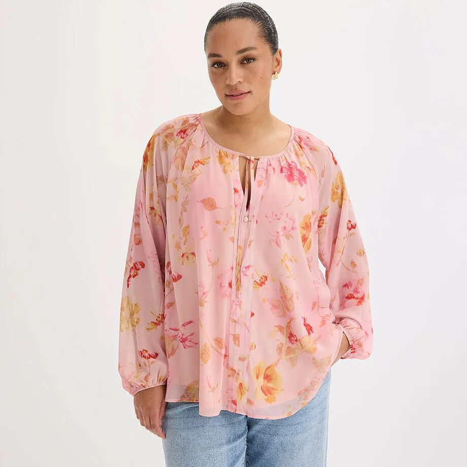 Blusa rosa dal taglio morbido con motivo floreale colorato e laccetti decorativi sullo scollo.
