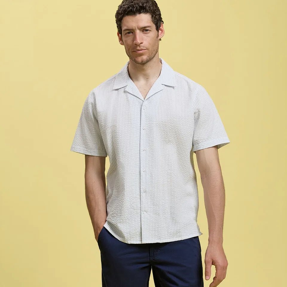 Camicia leggera a maniche corte con pantaloni scuri, perfetta per le giornate calde.