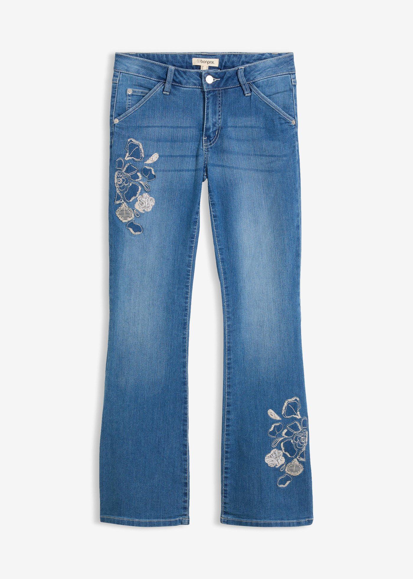 Jeans a zampa con ricami floreali