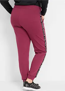 Pantaloni in felpa con fascette e scritta statement, bonprix