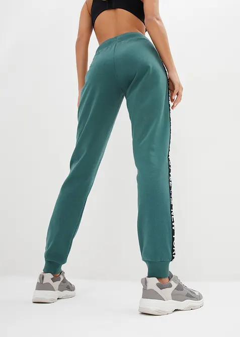 Pantaloni in felpa con elastico in vita e stampa con scritta, bonprix