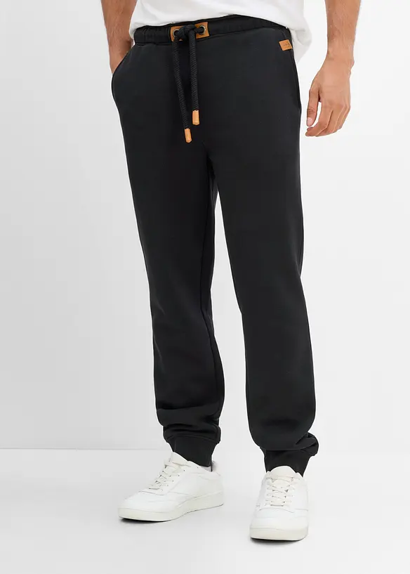 Pantaloni da jogging pesanti con dettagli in PU, bonprix